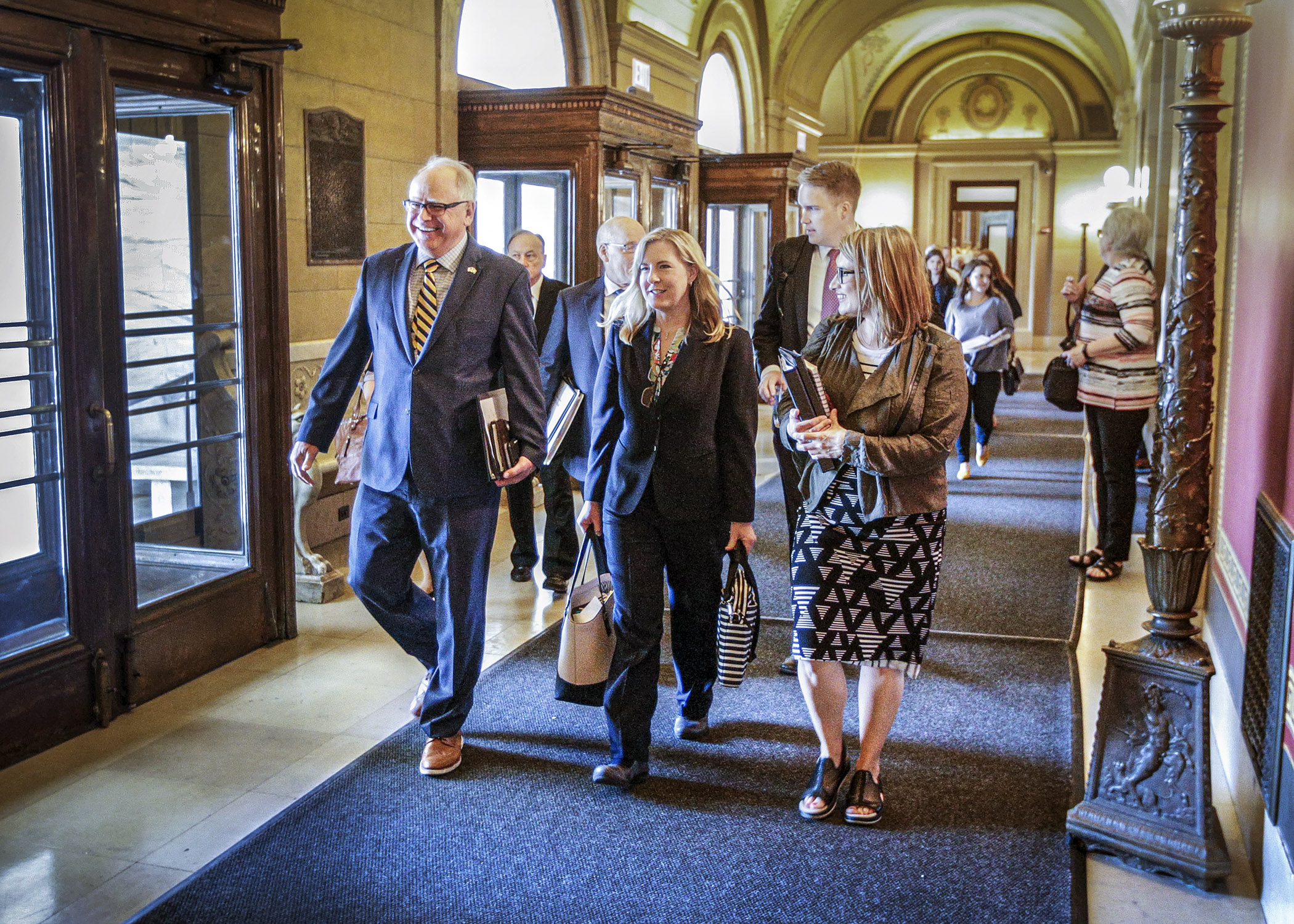 Gov. Tim Walz, House Speaker Melissa Hortman and Lt. Gov. Peggy Flanagan stride past the front doors of the Capitol en route to Tuesday afternoon’s budget negotiations with Senate Majority Leader Paul Gazelka and others. Photo by Paul Battaglia